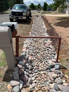 Decorative rock and culvert pipe in ditch